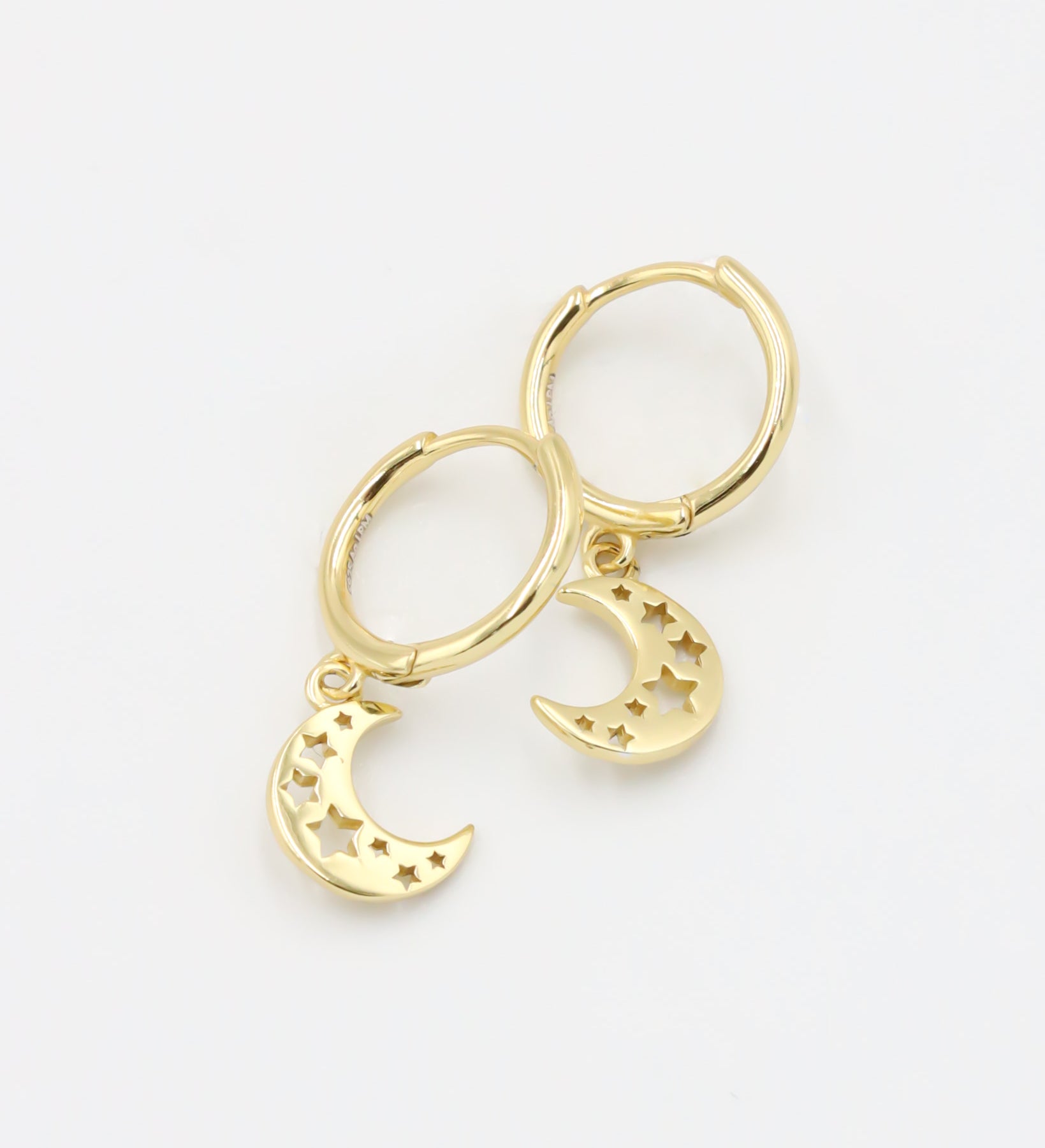 A gold-colored hoop earring with a crescent moon charm attached, set on a white background.