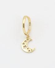 A gold-colored hoop earring with a crescent moon charm attached, set on a white background.
