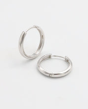 A pair of silver hoop earrings with a hinged clasp, displayed on a white background.