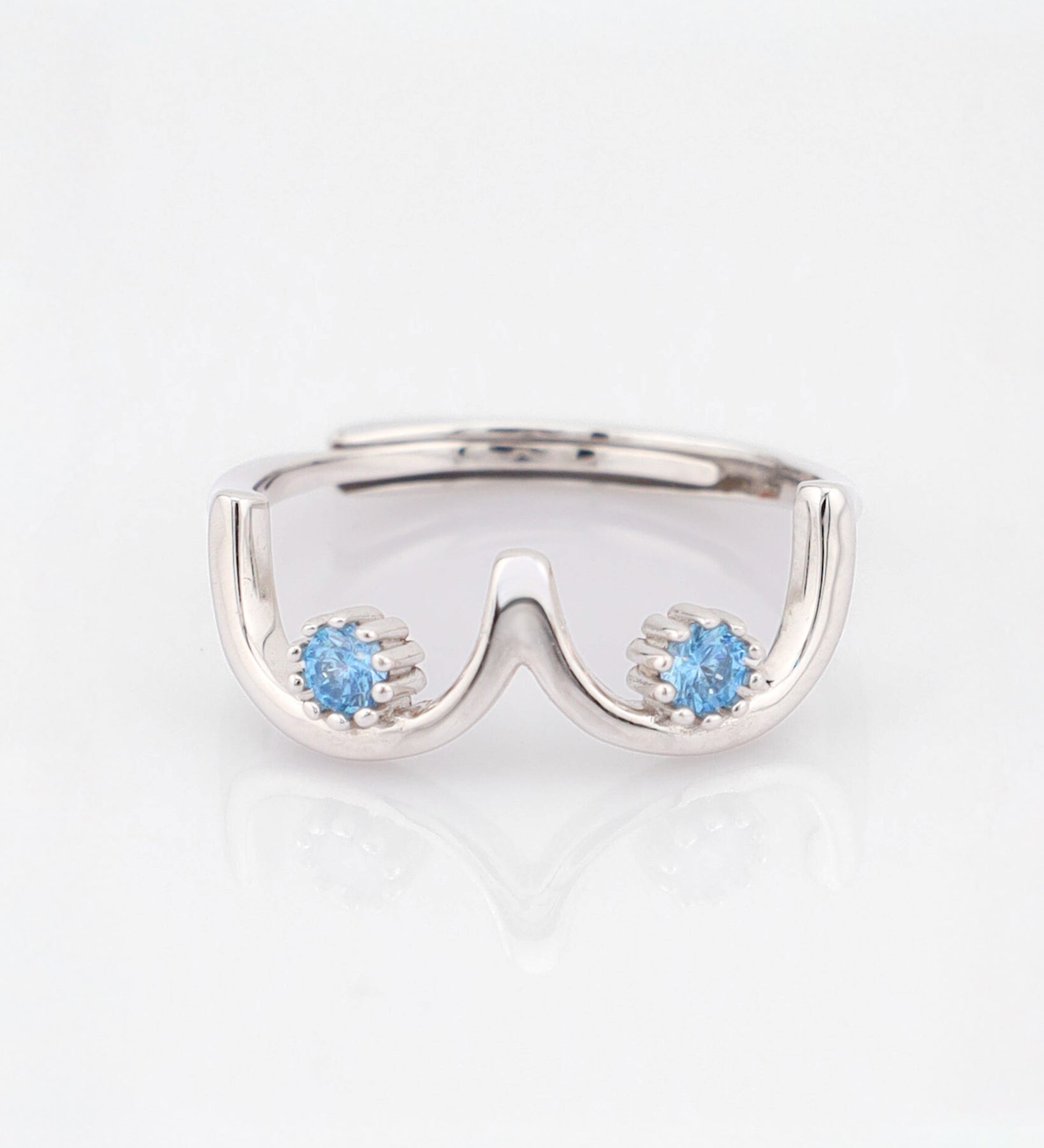 Silver ring with blue gemstones on a white background