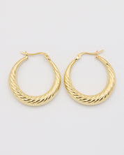 A pair of gold-colored hoop earrings with a latch back clasp on a white background.