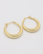 A pair of gold-colored hoop earrings with a latch back clasp on a white background.