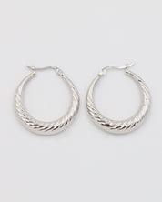 A pair of silver-colored hoop earrings with a latch back clasp.