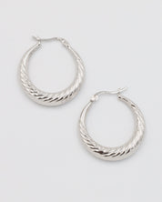 A pair of silver-colored hoop earrings with a latch back clasp.
