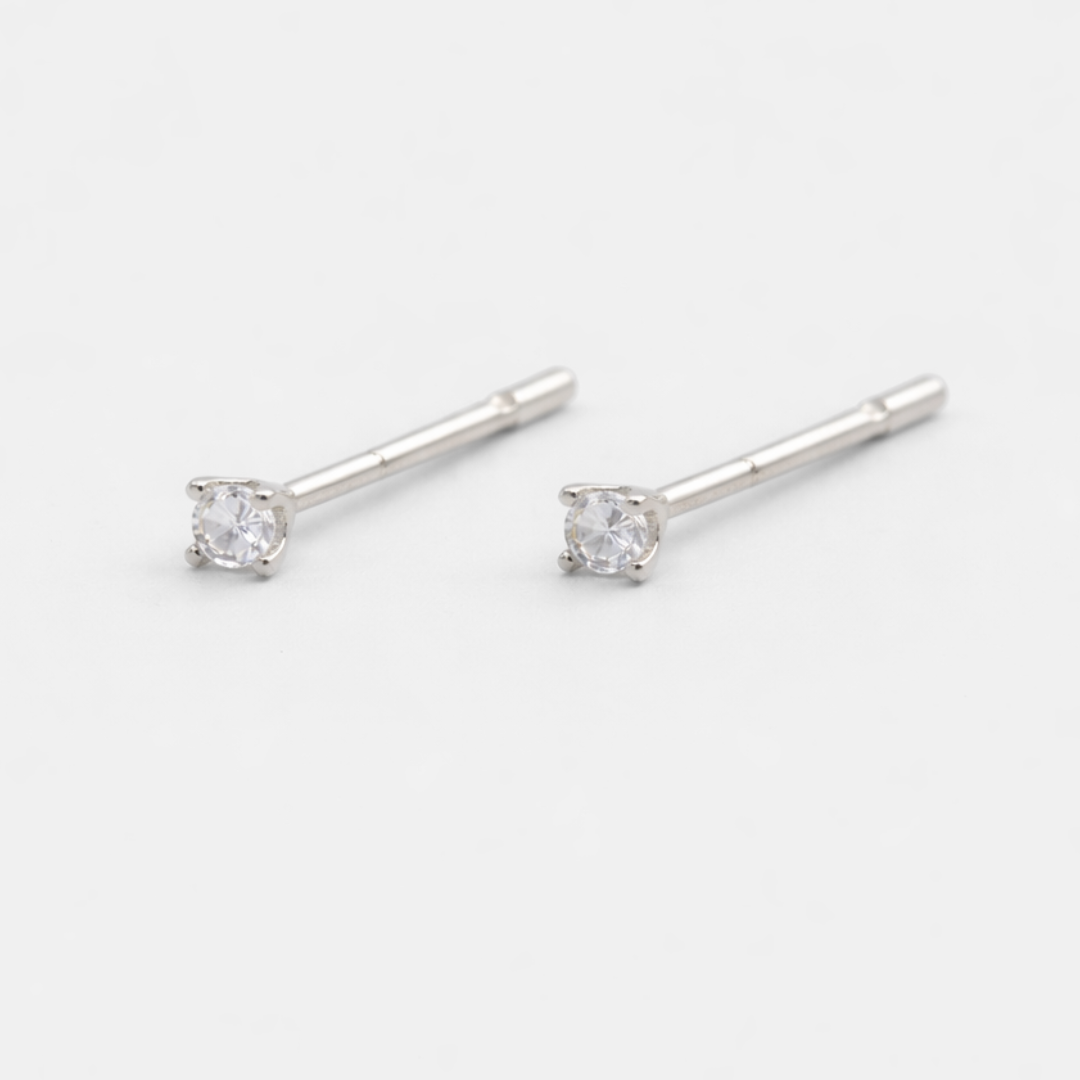 Silver stud earrings with clear gemstones on a white background