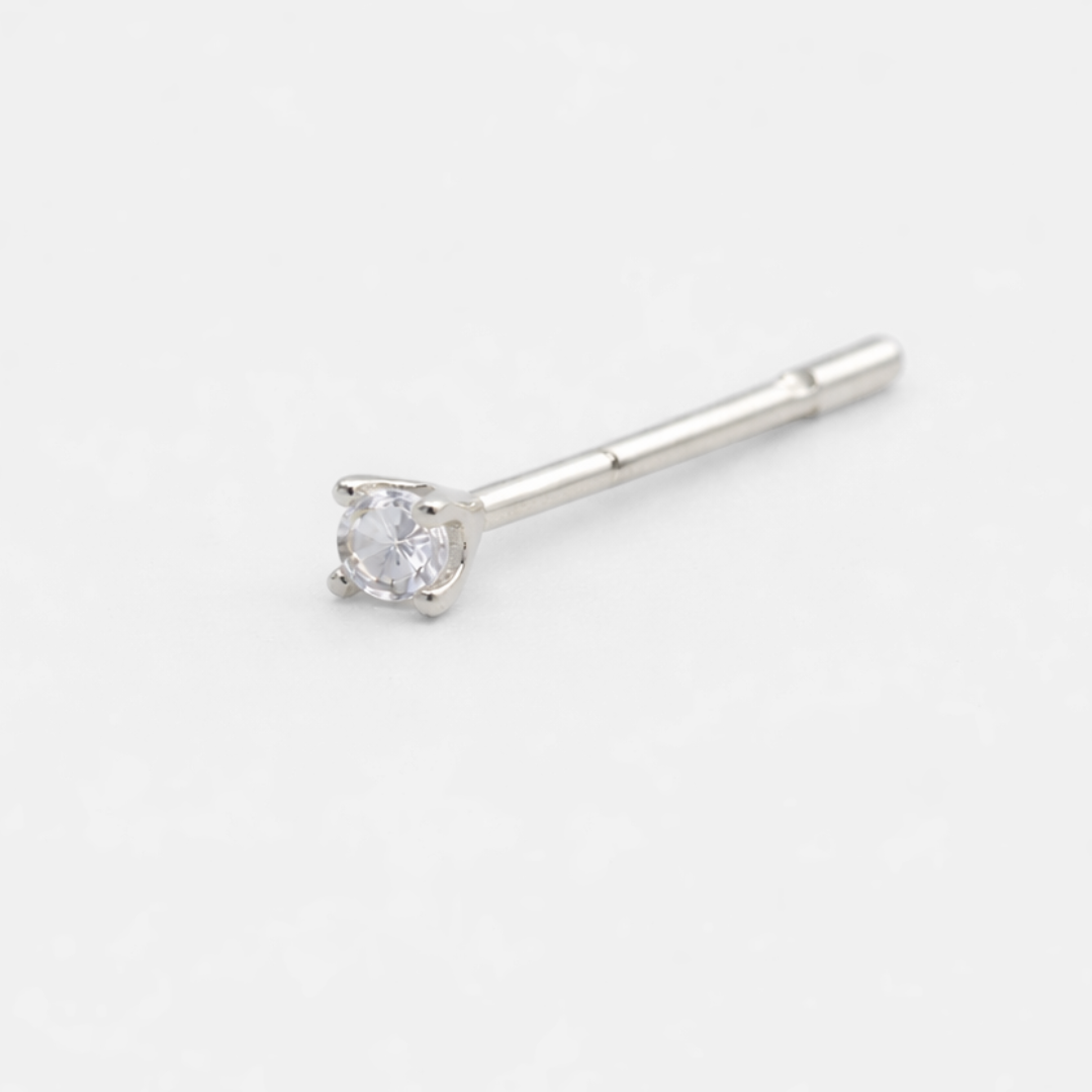 Silver stud earring with a clear gemstone on a white background