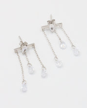 A pair of silver earrings with a stud closure and dangling chain detailed with small clear crystals.