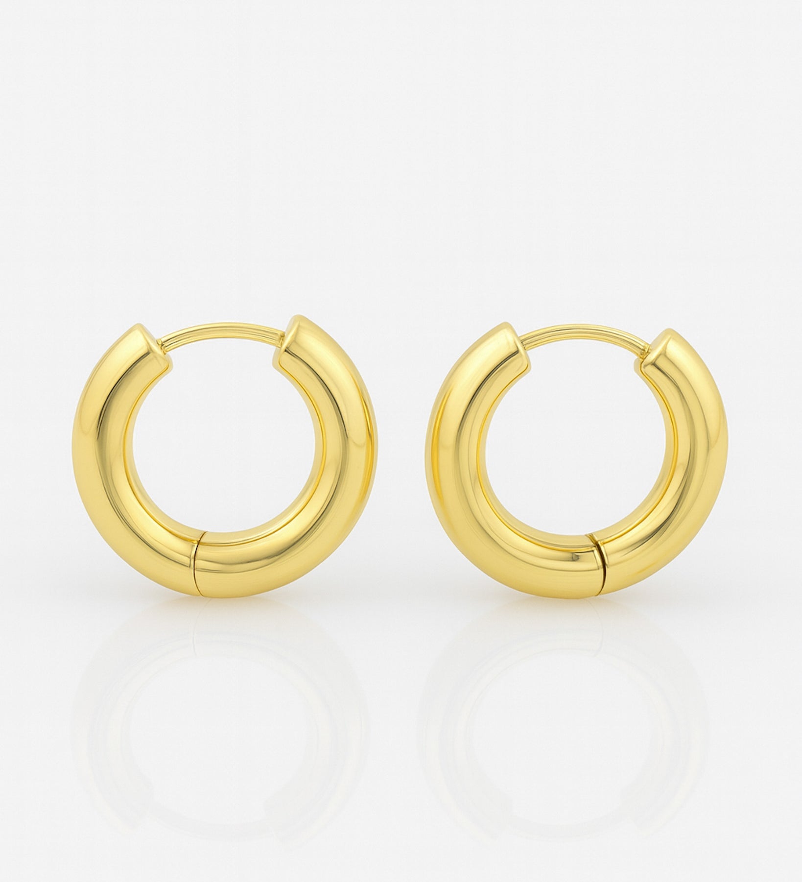 Gold hoop earrings on a white background