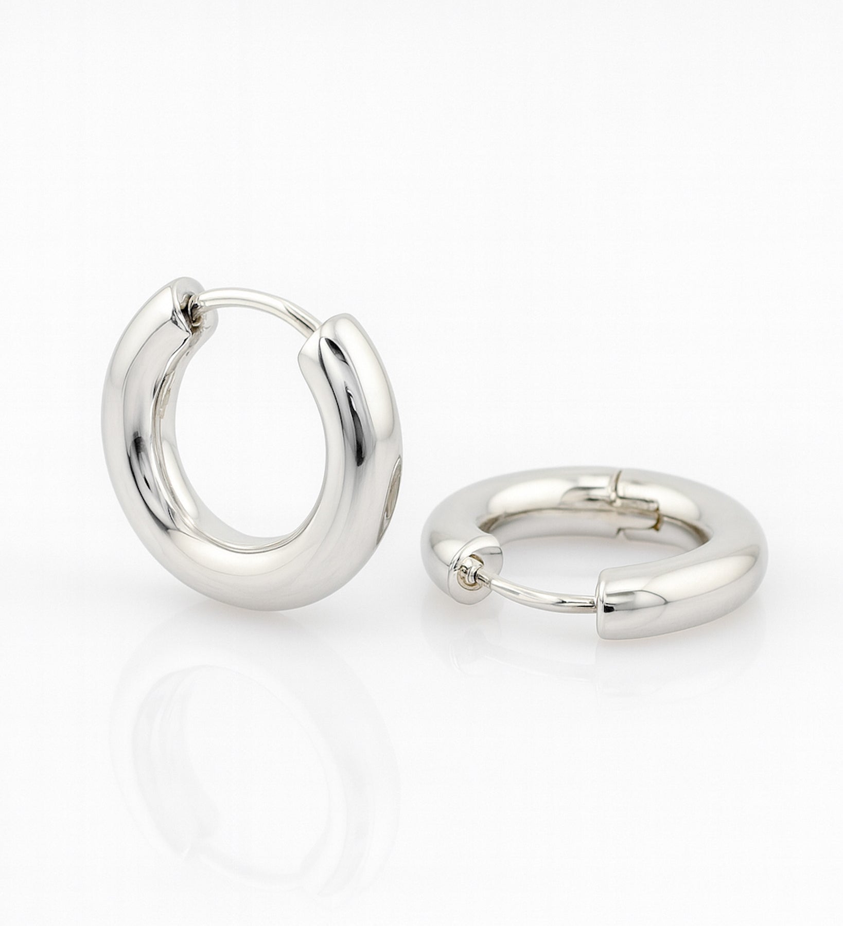 Pair of silver hoop earrings on a white background