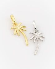 Gold and silver palm tree pendants on a white background