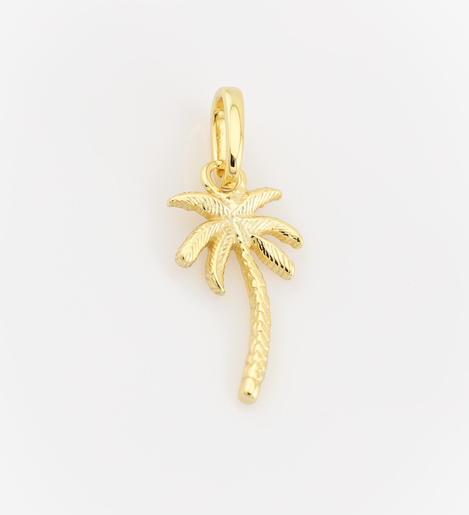 Gold palm tree pendant on a light gray background