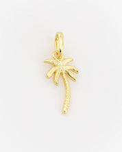 Gold palm tree pendant on a light gray background