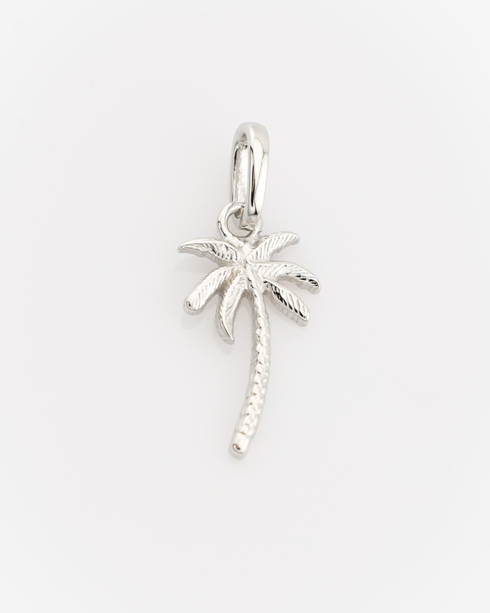 Silver palm tree pendant on a light gray background