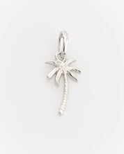 Silver palm tree pendant on a light gray background
