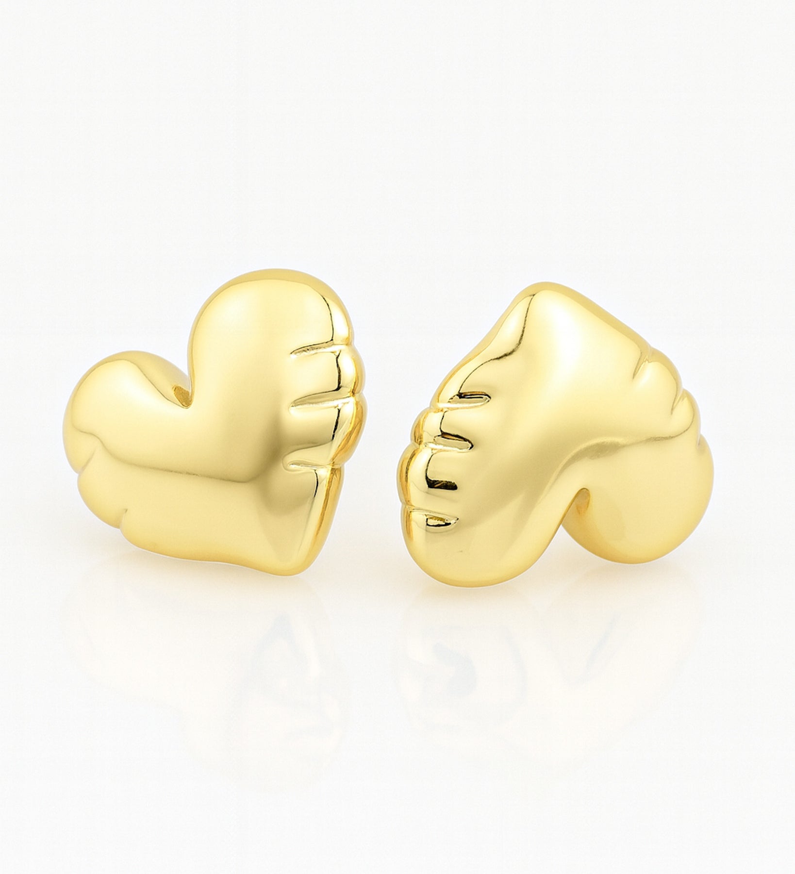 Gold heart-shaped earrings on a white background