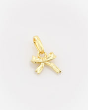 Gold bow-shaped pendant on a light gray background