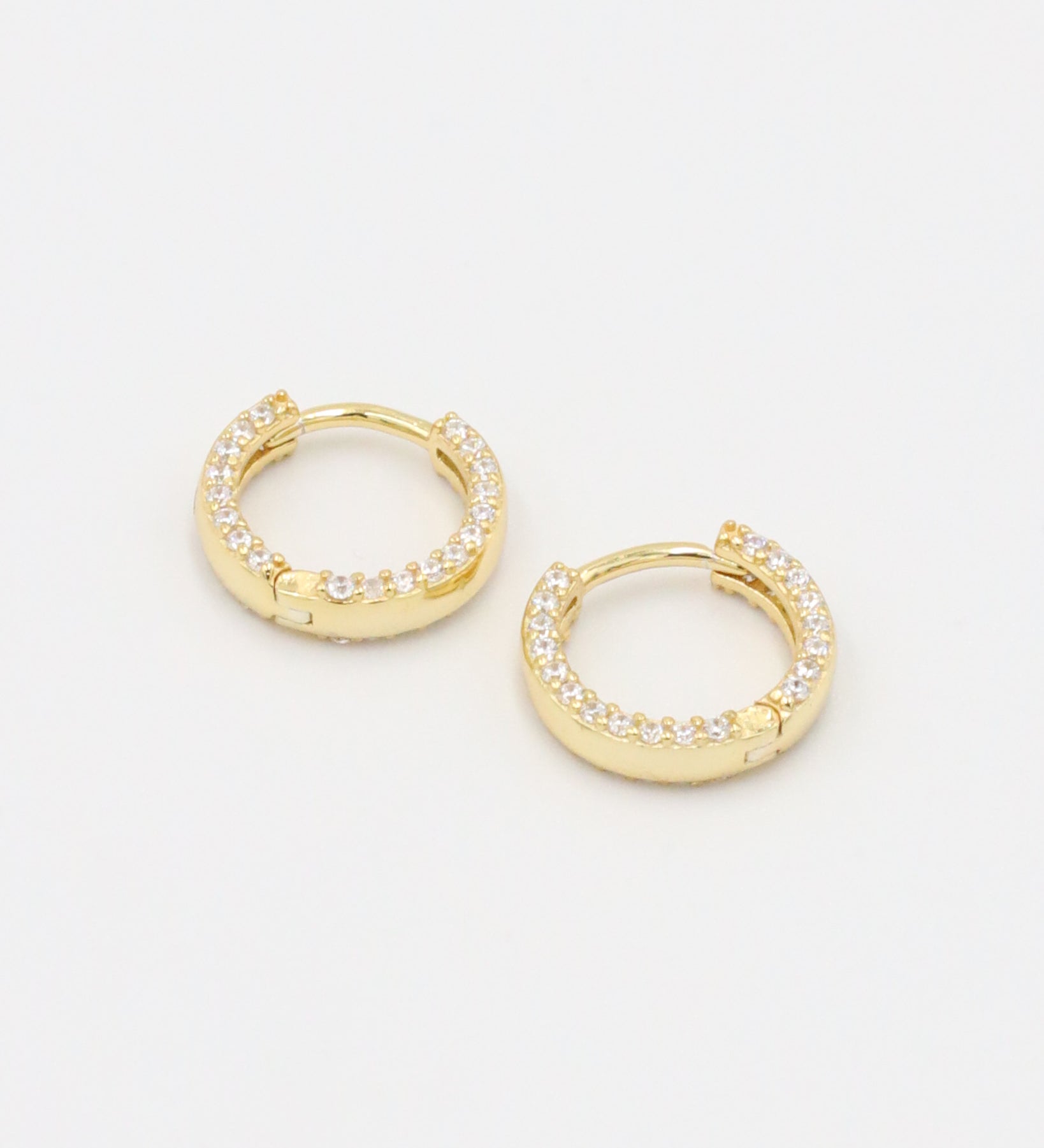 Pair of gold-plated sterling silver Mara hoop earrings, beautifully adorned with a full pavé of sparkling zirconia stones.