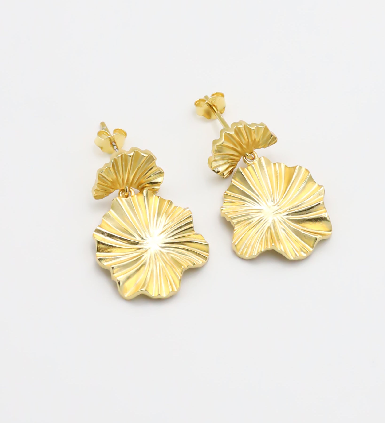 A pair of gold-colored floral design earrings with a butterfly clasp closure.