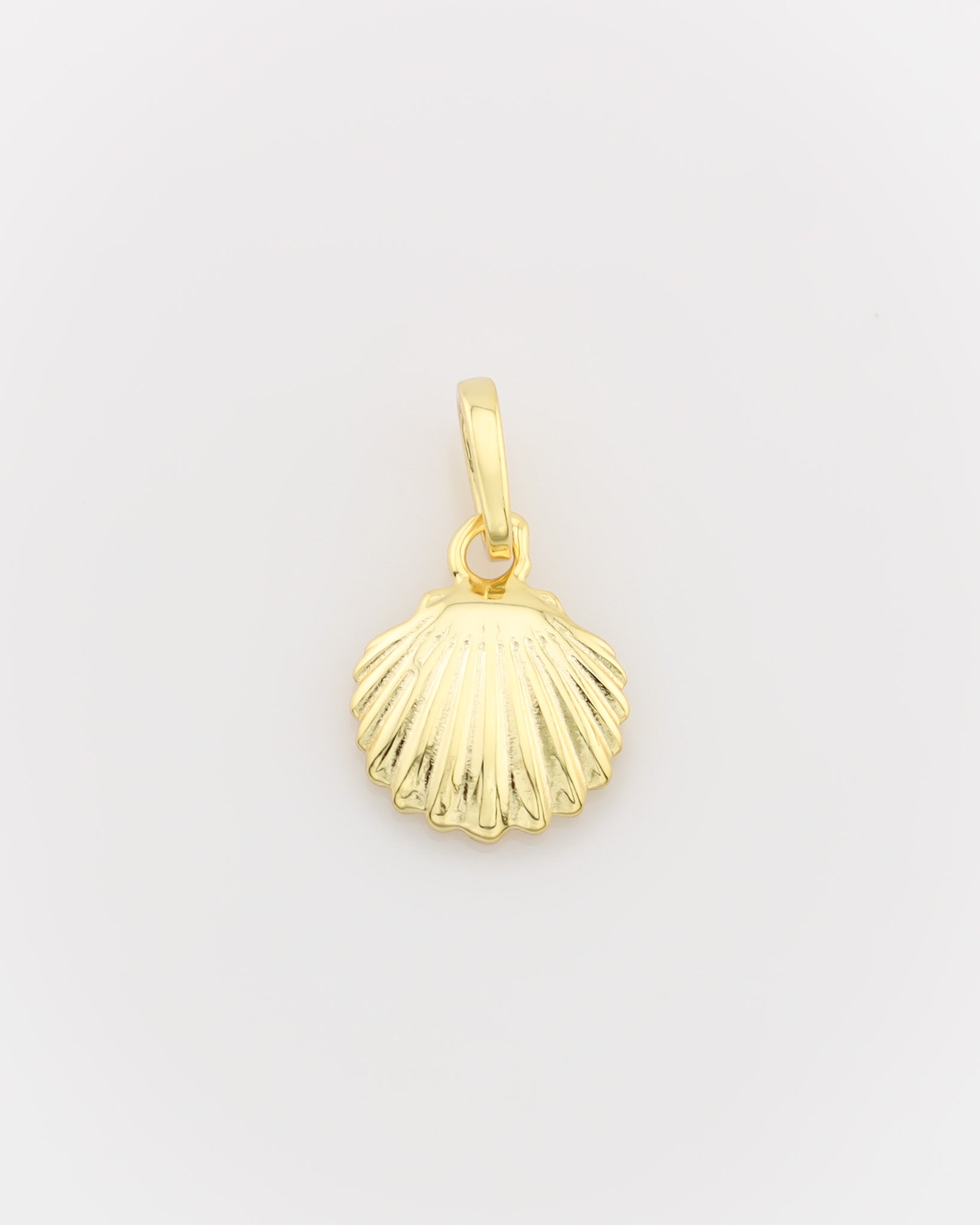 Gold shell pendant on a light gray background