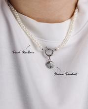 Pearl necklace with a silver pendant on a white shirt