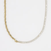 A gold-plated sterling silver necklace with a chain link design and adorned with small clear stones.