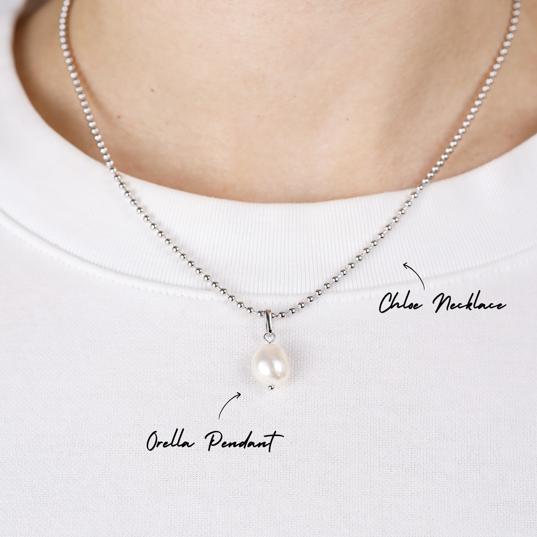 Pearl necklace with pendant on a white background