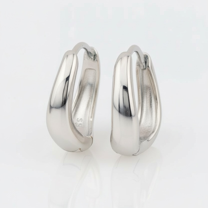Pair of silver hoop earrings on a white background
