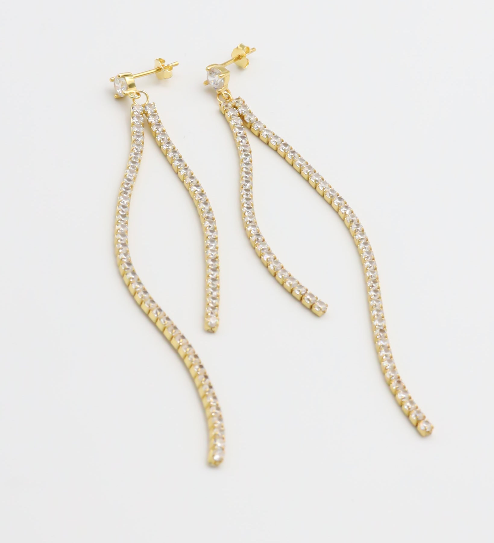 A pair of gold-colored stud earrings with small crystal embellishments.