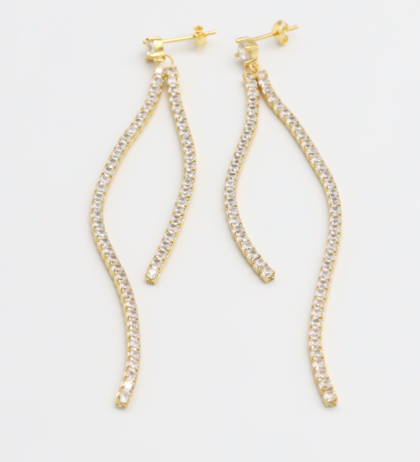A pair of gold-colored stud earrings with small crystal embellishments.
