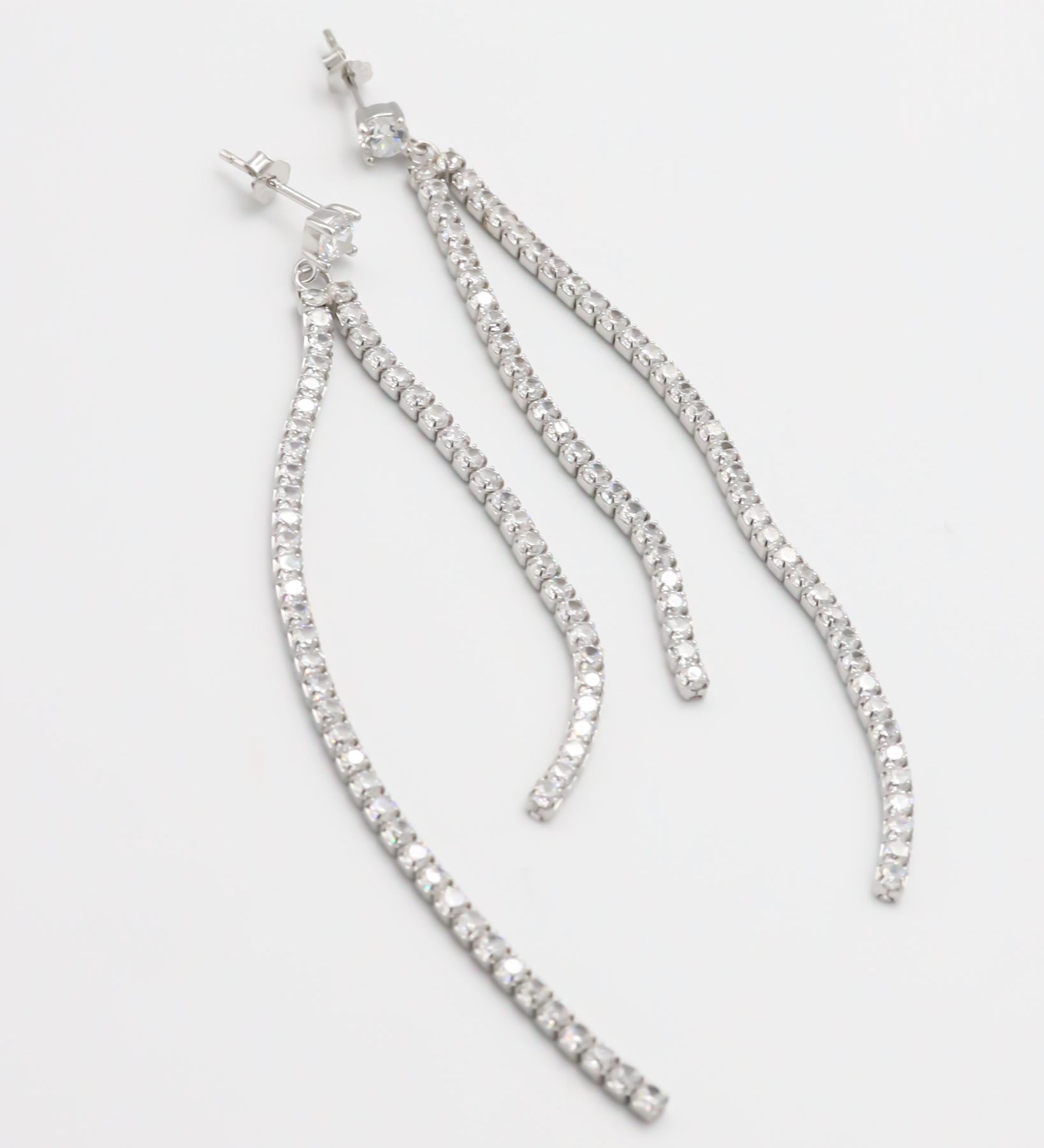 A pair of silver-colored stud earrings with small crystal embellishments.