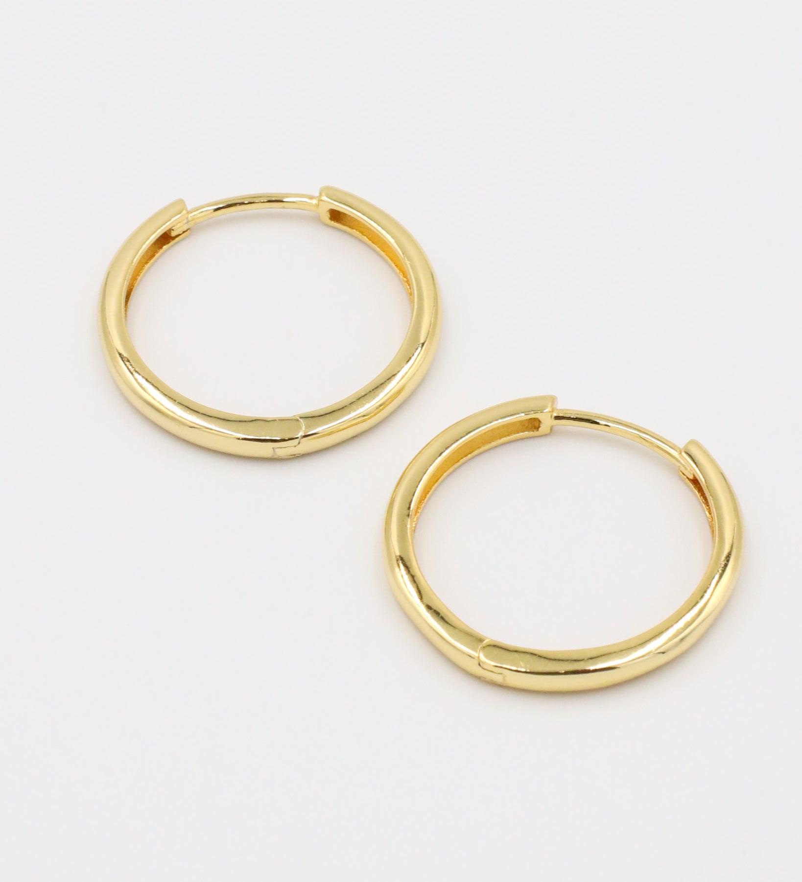Side view of Rachele hoop earrings, crafted from gold-plated sterling silver, showing the classic hoop shape.