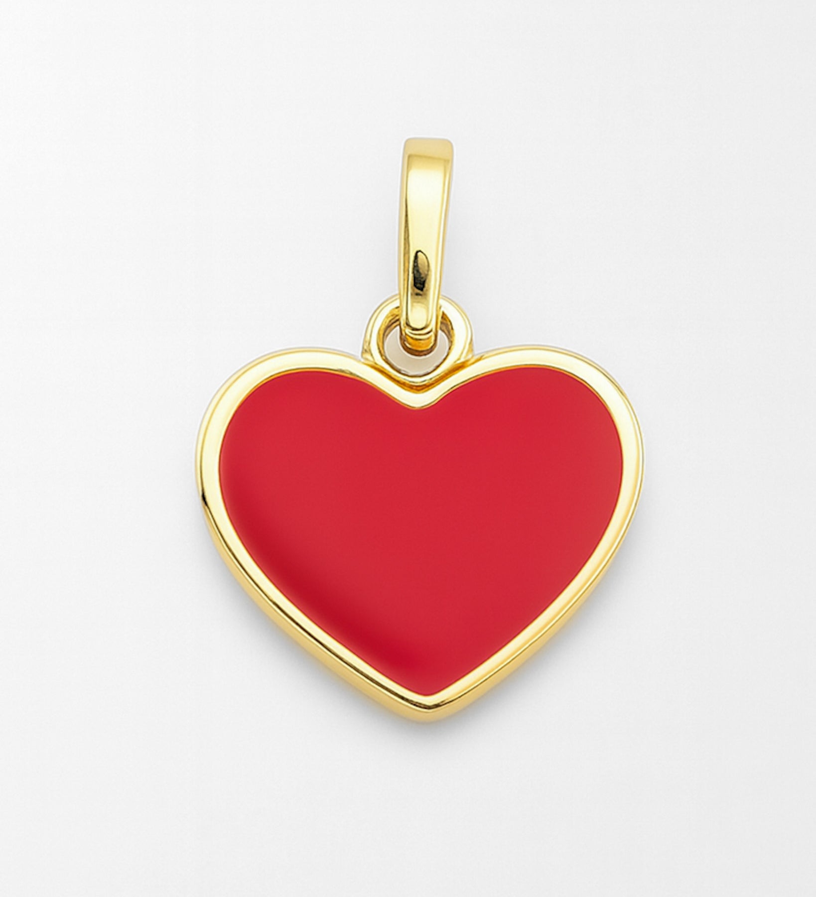 Gold heart-shaped pendant with red center on a white background