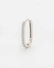 Silver colored hoop earring with a row of inset stones on the hoop, displayed against a white background.