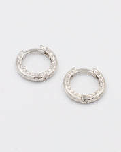 A pair of silver hoop earrings with a patterned design.