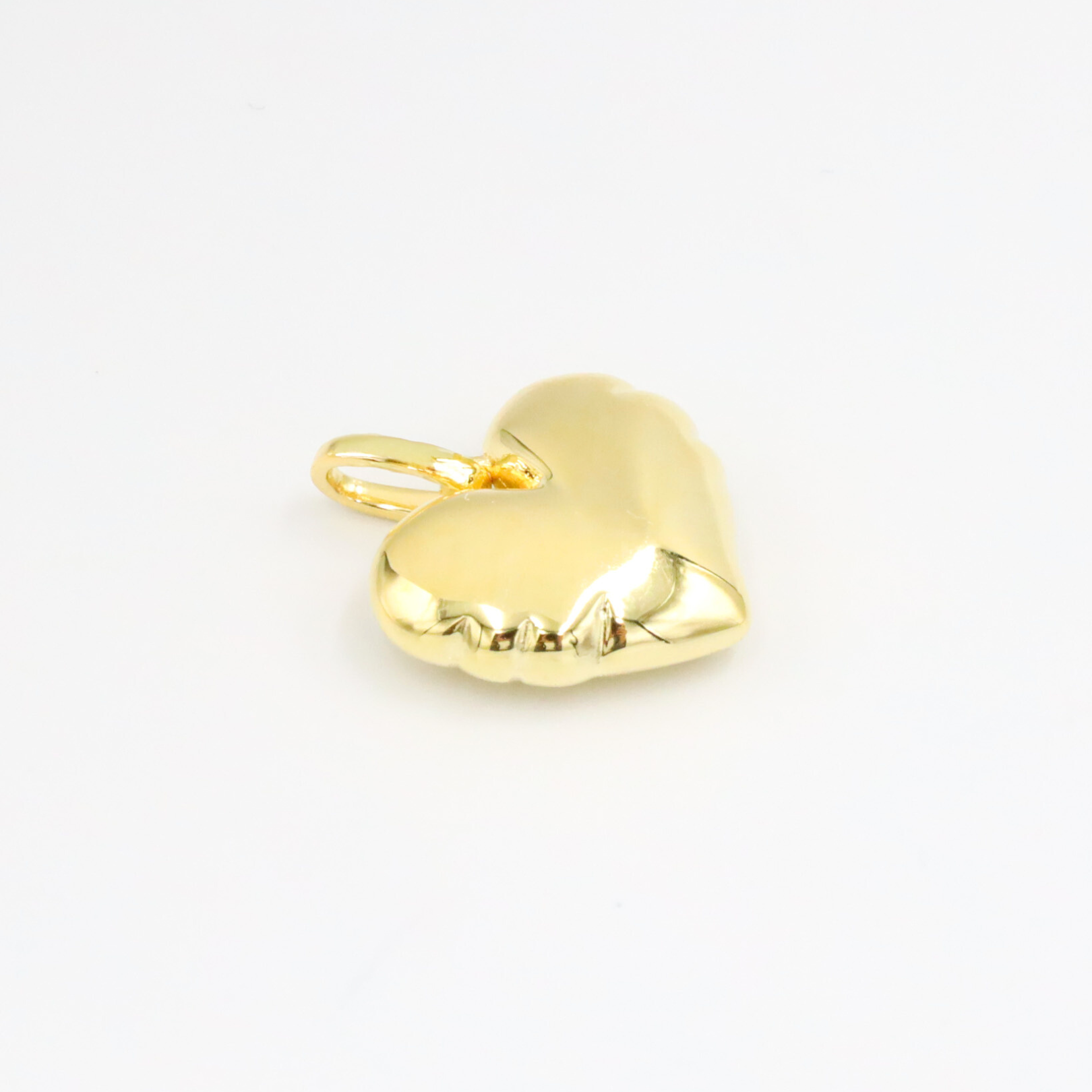 Bella Gold heart-shaped pendant in gold-plated 925 sterling silver shown lying flat on a white surface.