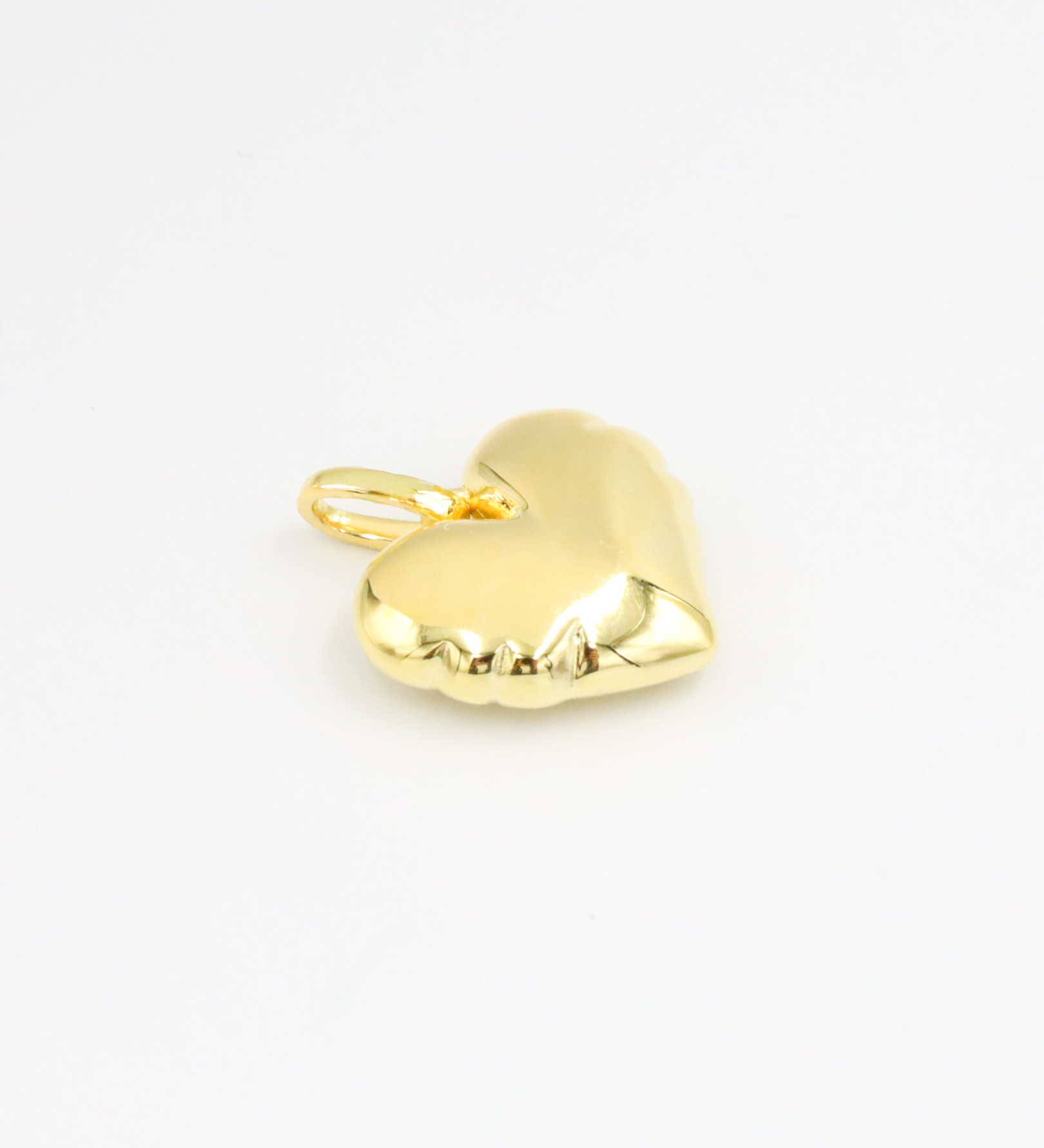 Bella Gold heart-shaped pendant in gold-plated 925 sterling silver shown lying flat on a white surface.