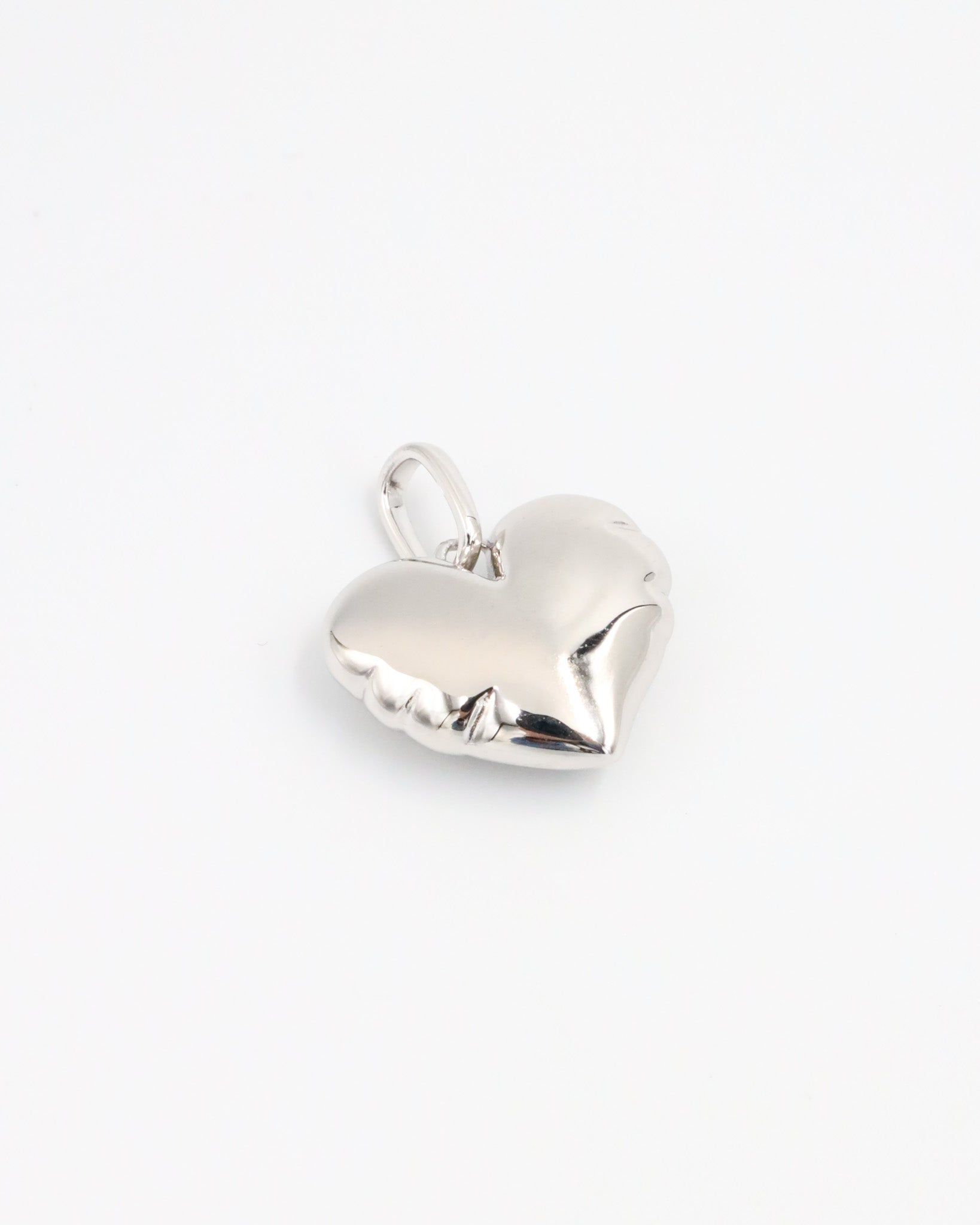 Side view of the Bella Silver heart pendant, showcasing its smooth, sculpted surface in rhodium-plated 925 sterling silver.