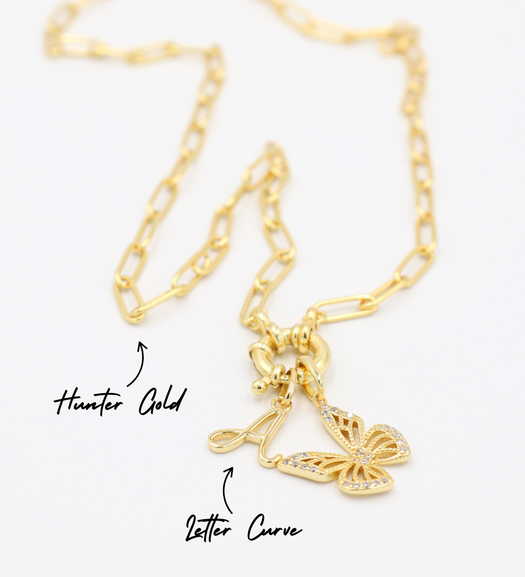 Hunter Gold chain necklace featuring a combination of the Letter Curve "A" pendant and the Butterfly Gold pendant with zirconia stones, all in gold-plated 925 sterling silver.