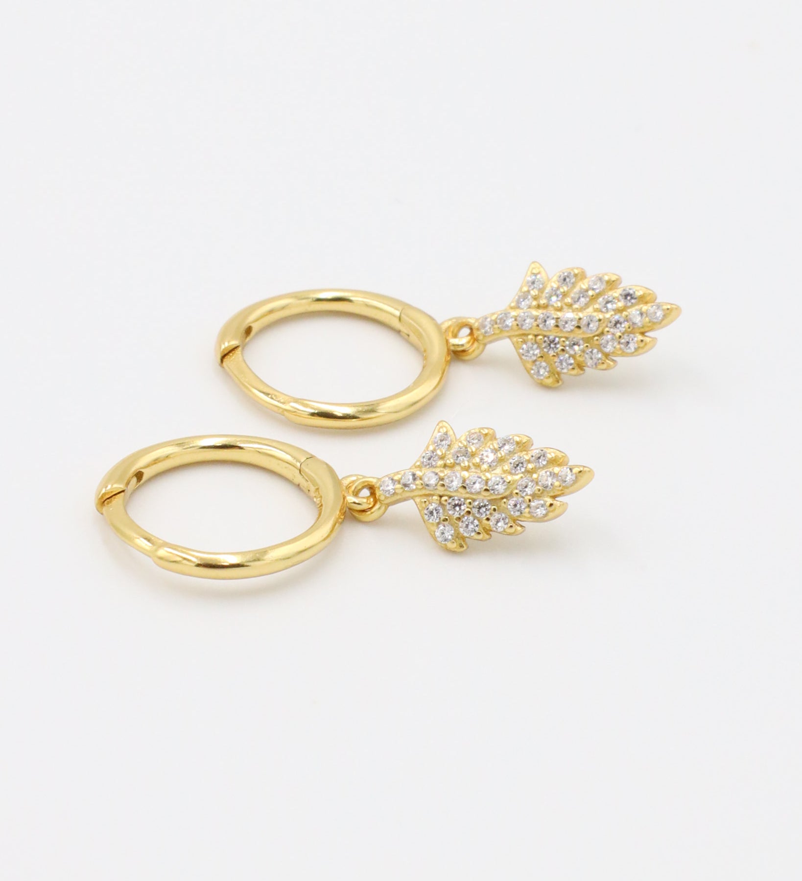 Pair of gold-plated sterling silver hoop earrings with leaf design and zirconia stones