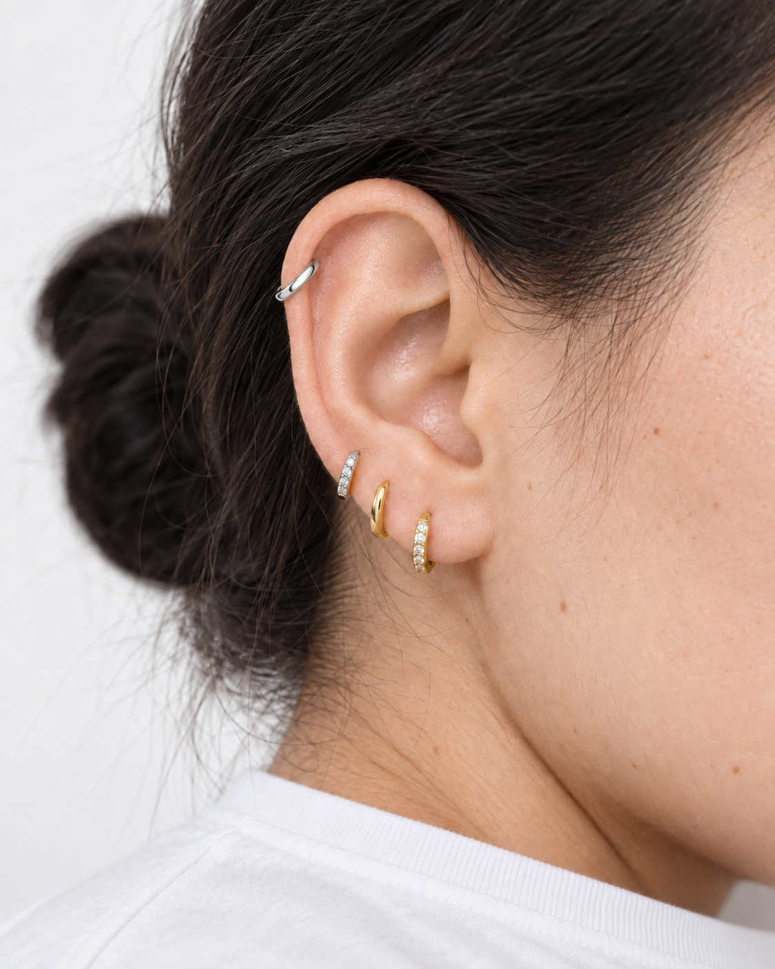 Ear stack with Jean Sparkly Earrings in silver and gold-plated 925 sterling silver, combined with a Lu Earring in the lobe and a silver hoop in the helix
