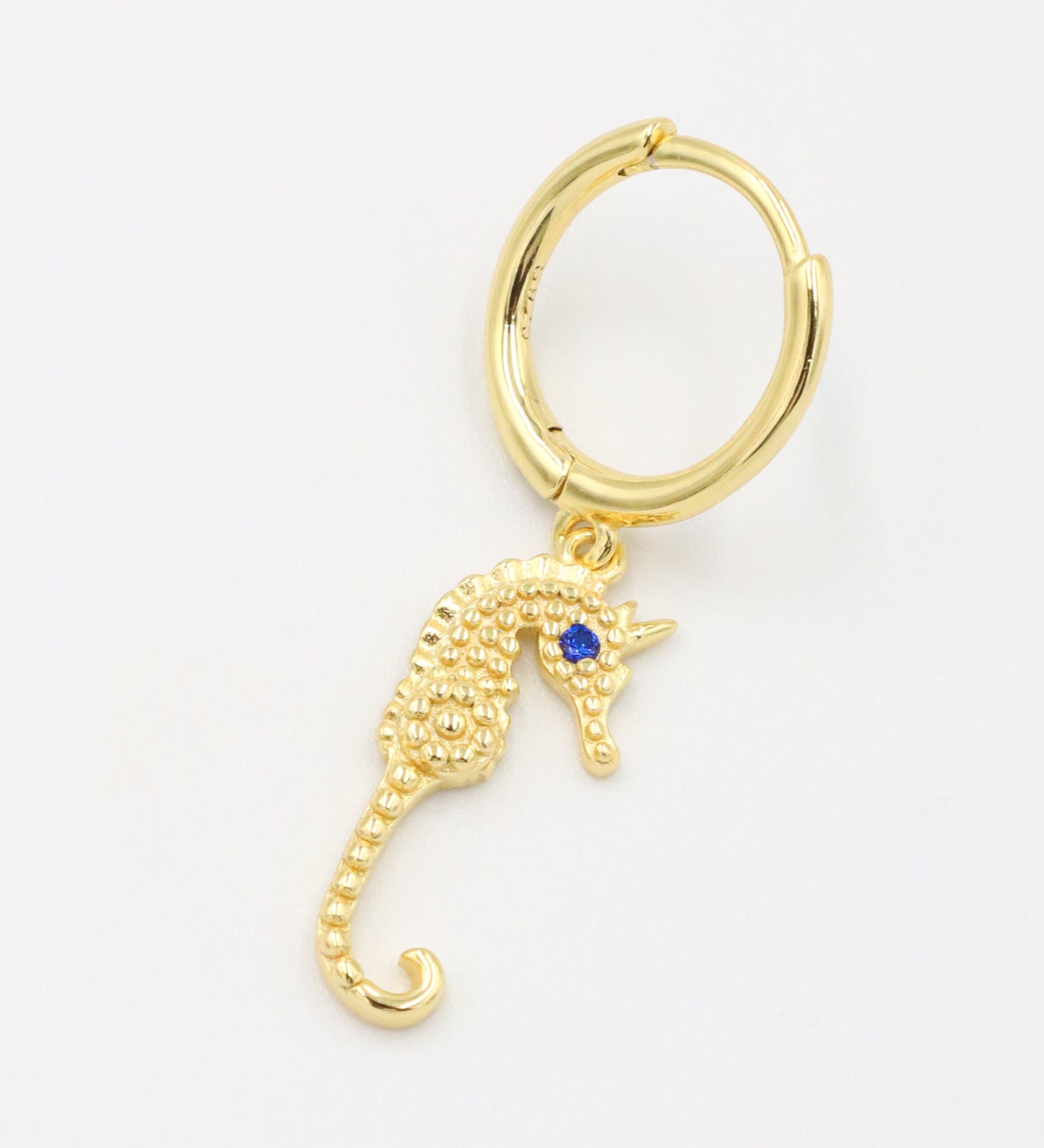 Single right Seahorse Gold earring with a gold-plated seahorse charm and blue zirconia eye.
