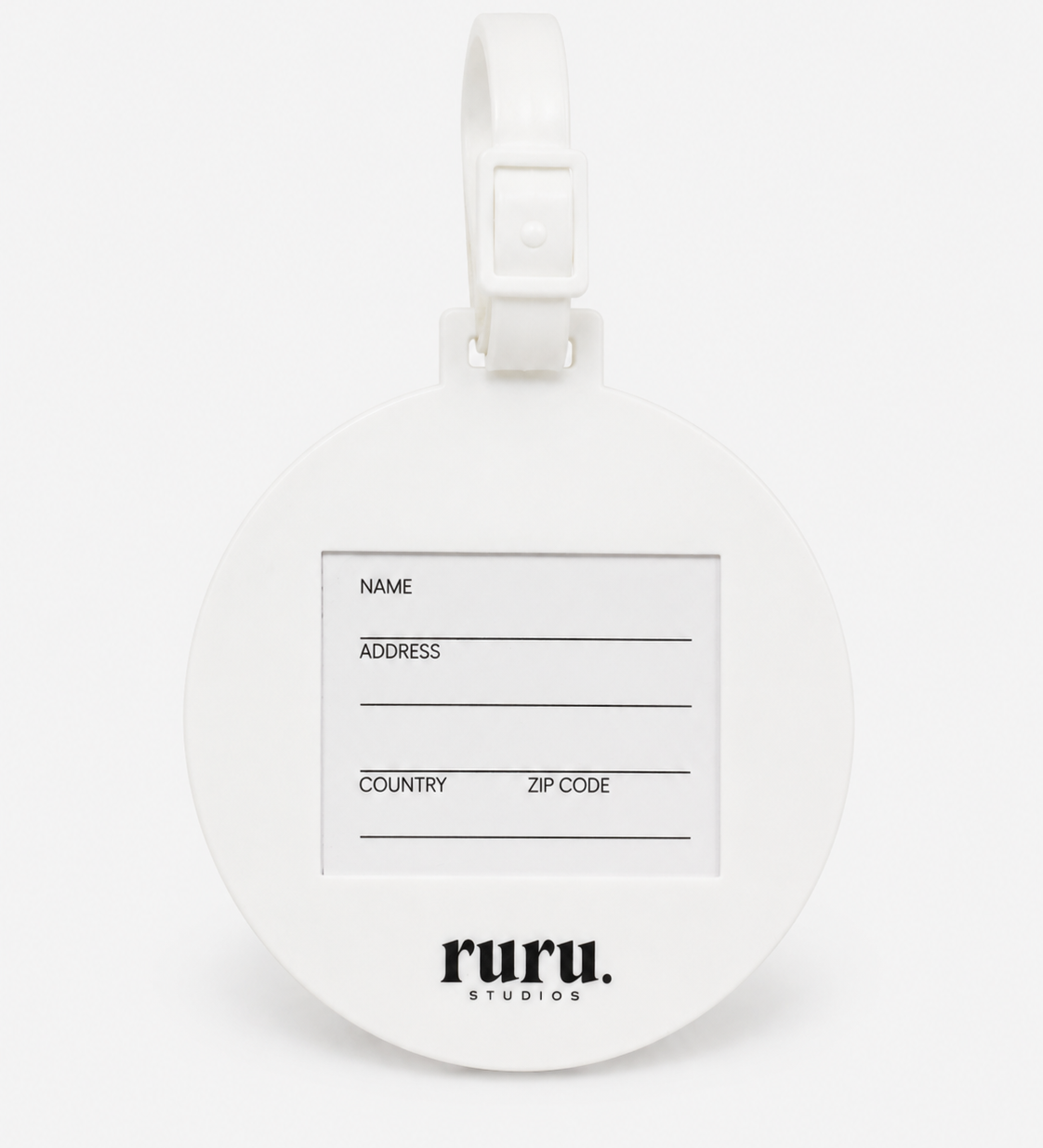 Back of the ruru. studios Smiley suitcase tag with address card and white loop on a clean white background