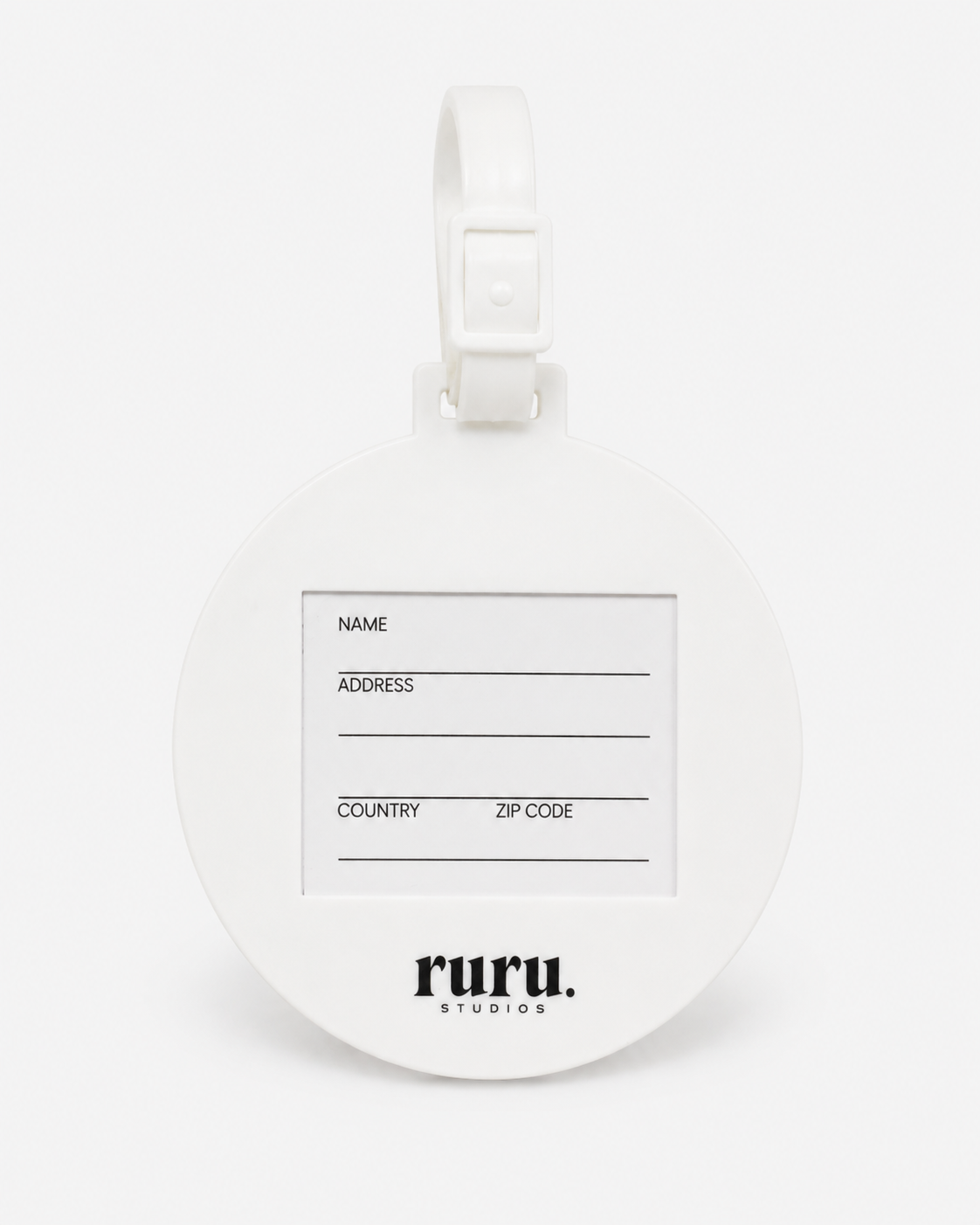 Back of the ruru. studios Smiley suitcase tag with address card and white loop on a clean white background