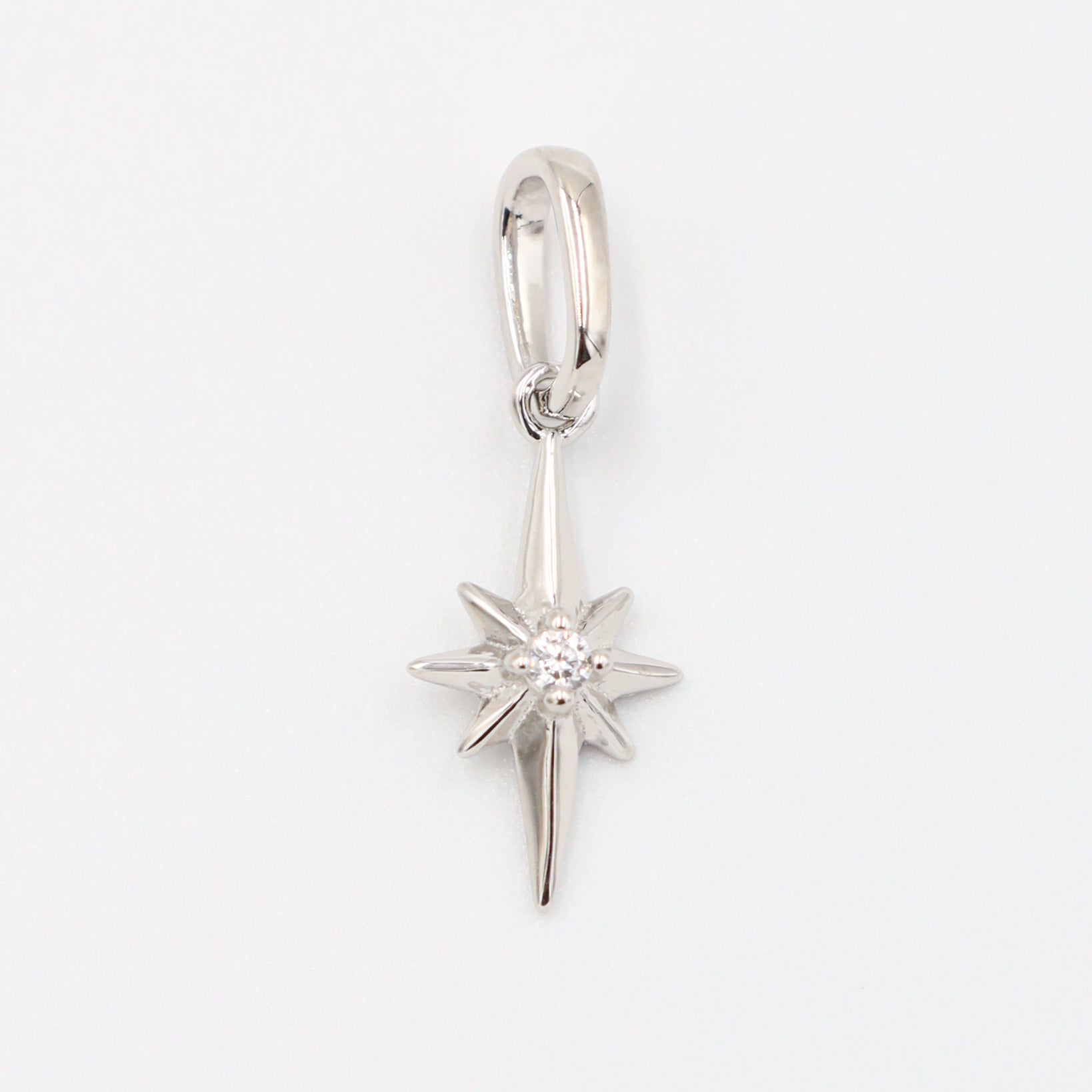 Close-up of a rhodium plated 925 sterling silver star pendant with a zirconia stone.